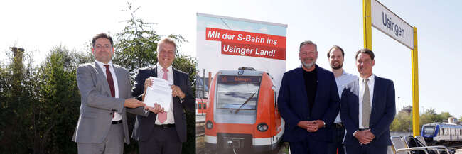 4 Männer zwei links zwei rechts, daneben ein Banner auf einem Bahnsteig in Usingen